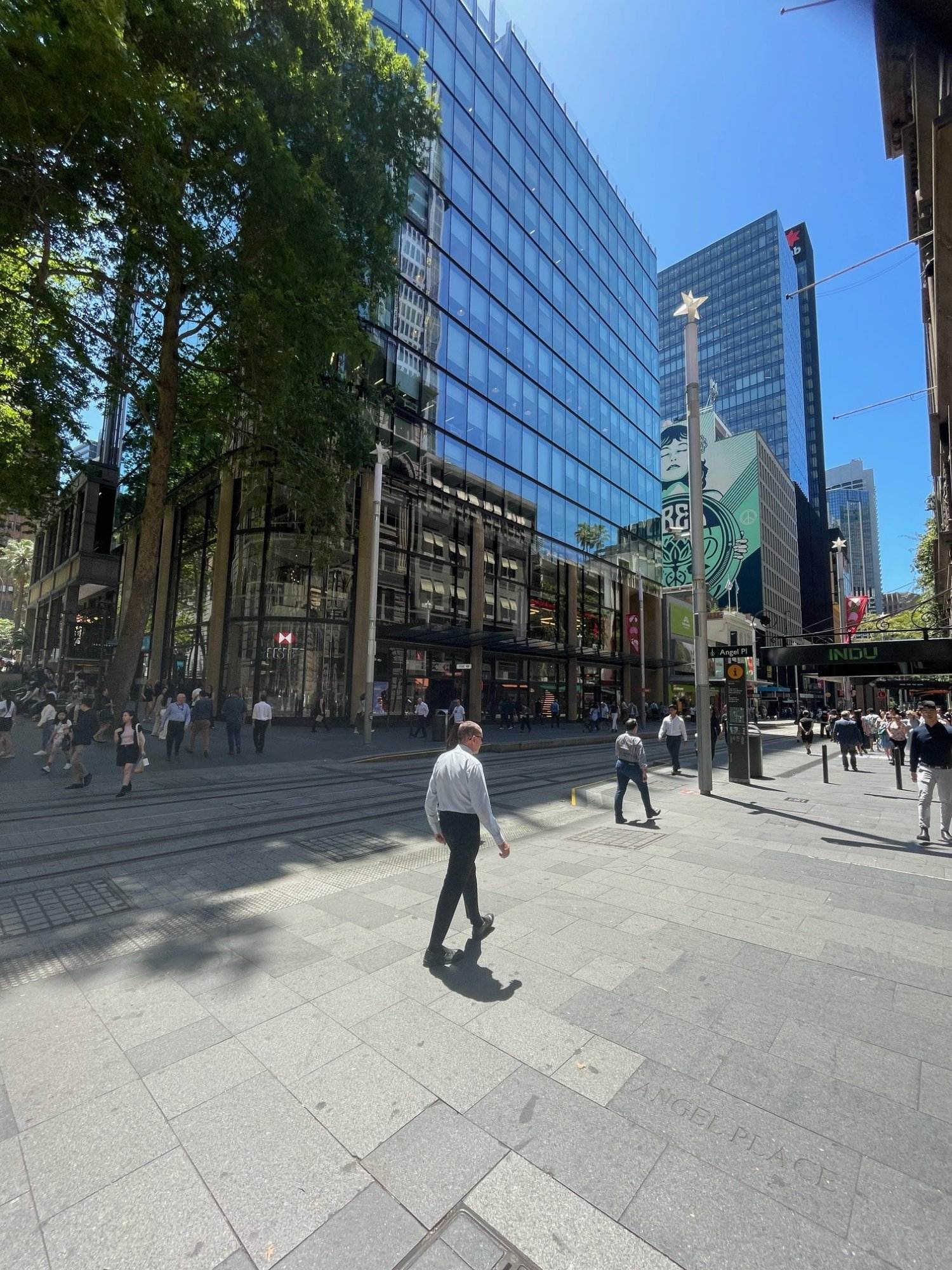Sydney street scene with modern glass buildings and pedestrians.